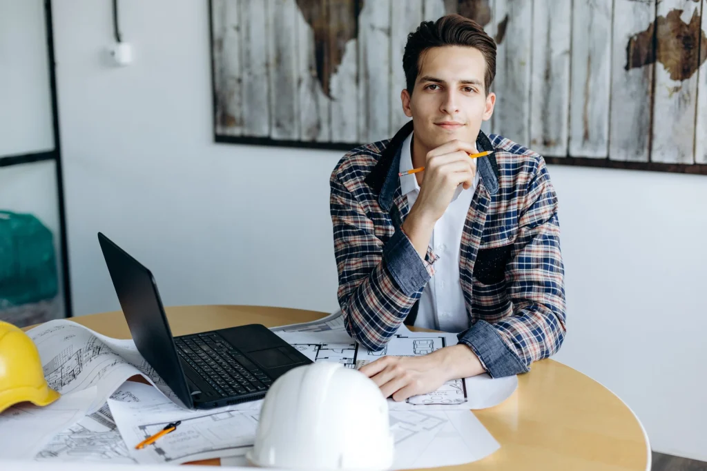 Headshot of a business guy in the office working on a drawing at his desk